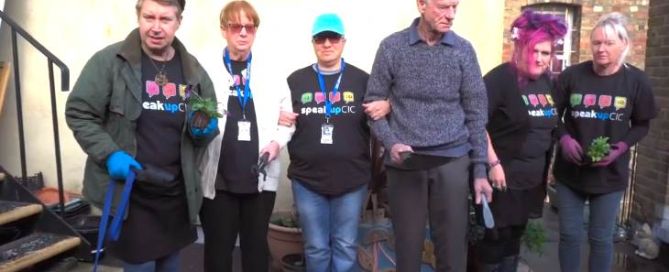 six people are standing next to each other in a back yard