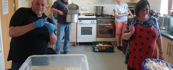 four people in a kitchen