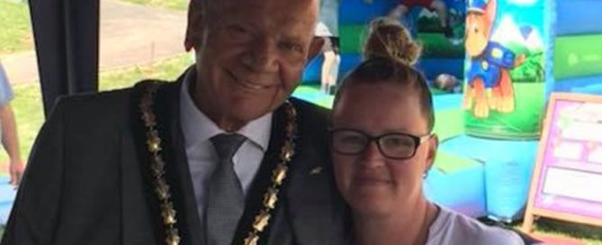 a man with a chain is next to a woman