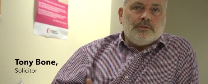 a man in a shirt looking at the interviewer