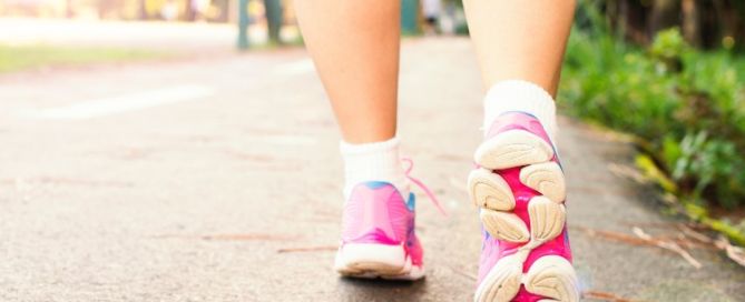 feet with pink trainers on doing light exercise
